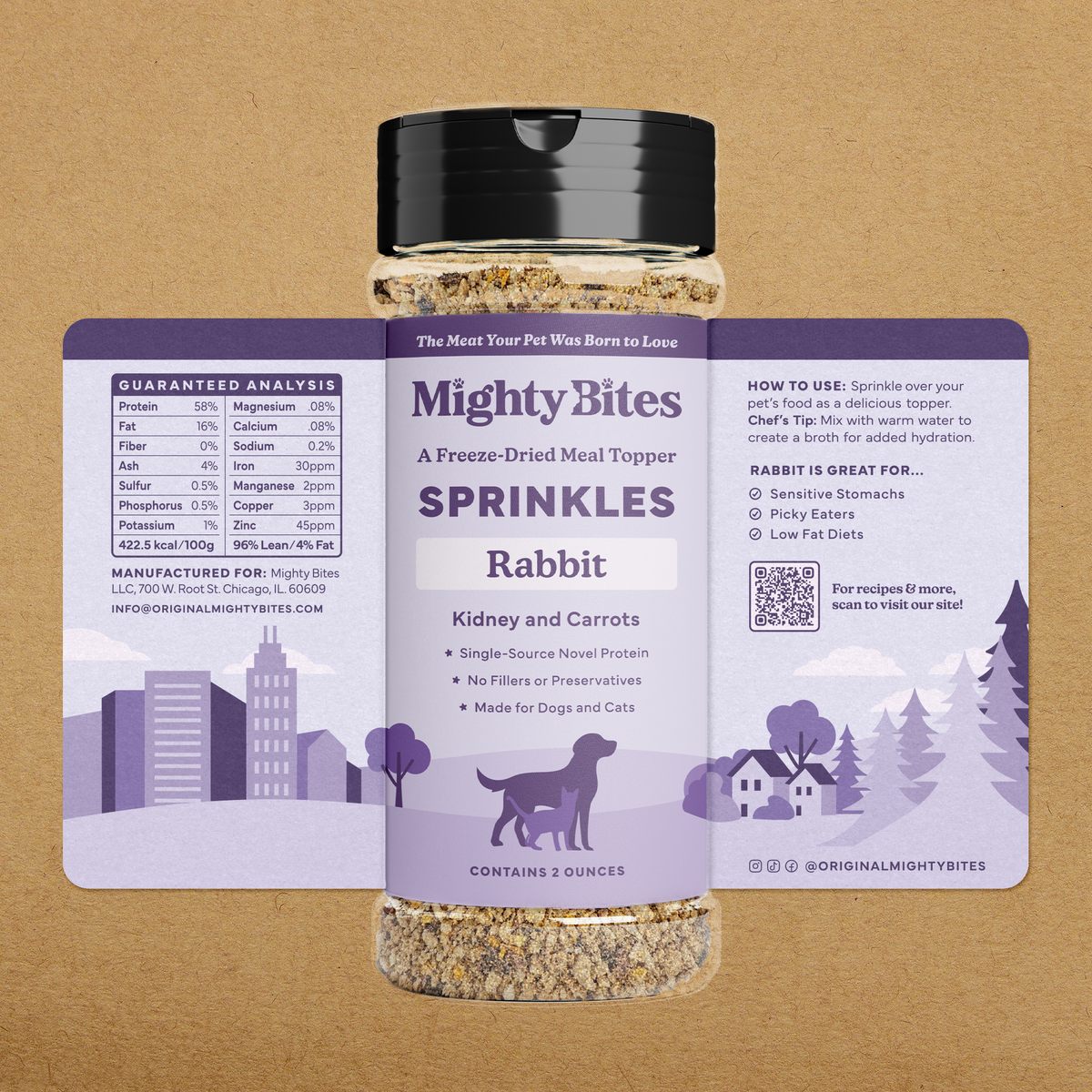 A bottle of Mighty Bites Rabbit, Kidney and Carrots freeze-dried meal topper sprinkles, featuring a lavender and white label with a black cap, set against a textured tan background.